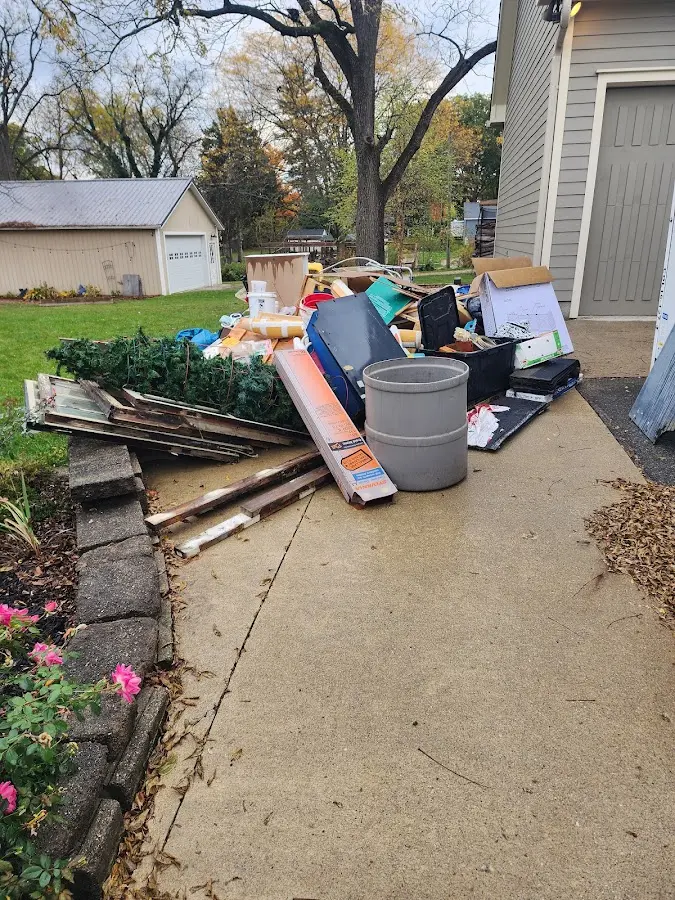 Dumpster being loaded with debris for Estate Cleanout Dumpster Rental in Tonawanda